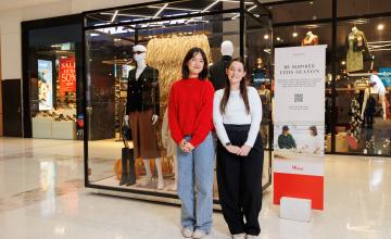 Two fashion students stand infront of fashion display at Westfield Carousel